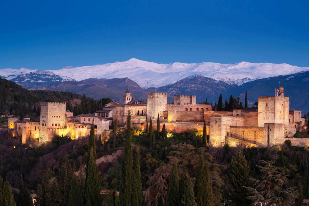 Andalucia Tour Package. The Alhambra, illuminated with Sierra Nevada in the background